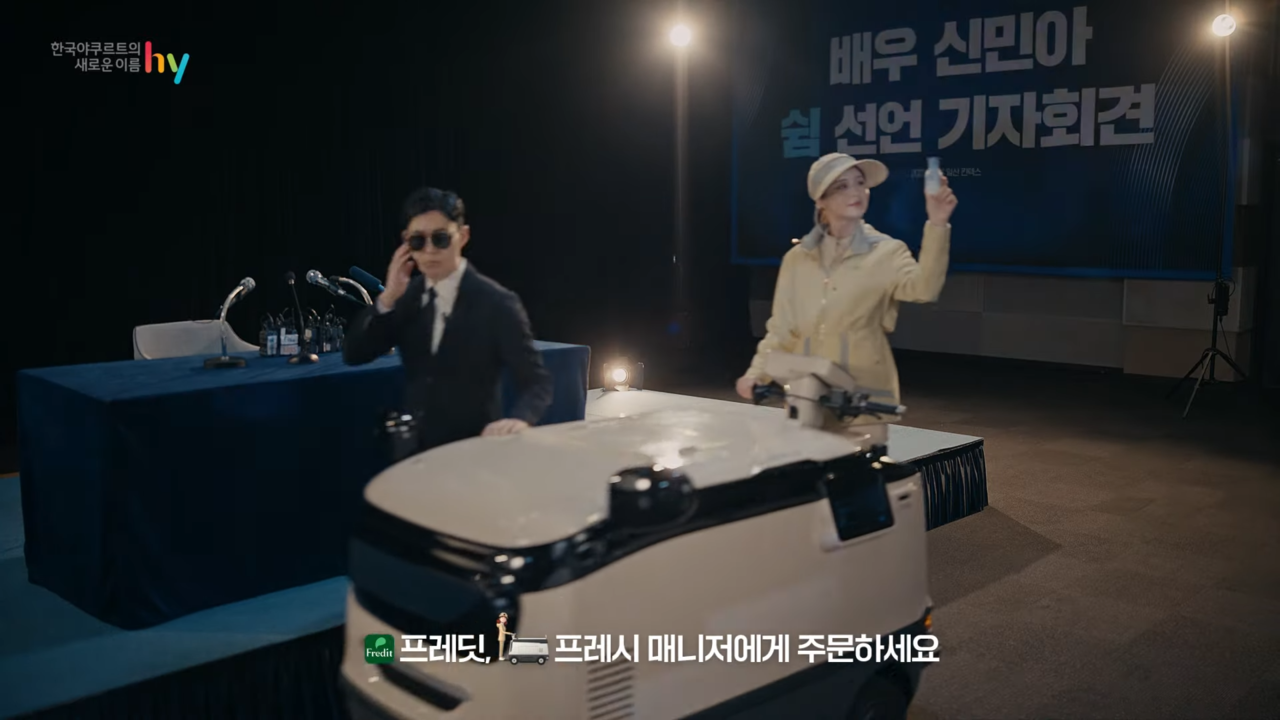 [AP신문 광고평론 No.736]  보디가드와 함께 지나가는 프레시 매니저. 자막으로 제품 구입 방법을 알린다. 사진 채널 hy 유튜브 캡처 ⓒAP신문