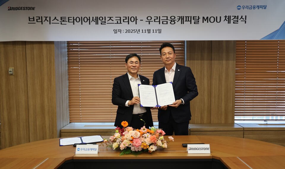 ©AP신문(AP뉴스)/이미지 제공 = 우리금융지주 ▲기동호 우리금융캐피탈 대표이사(왼쪽)와 김헌영 브리지스톤타이어세일즈코리아 대표이사가 지난 11일 우리금융캐피탈 서울본사에서 화물차주 상생 금융지원 업무협약 체결 후 기념촬영을 하고 있다.